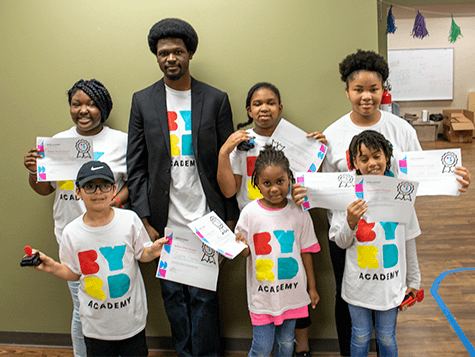 Students holding their certificates at a summer program